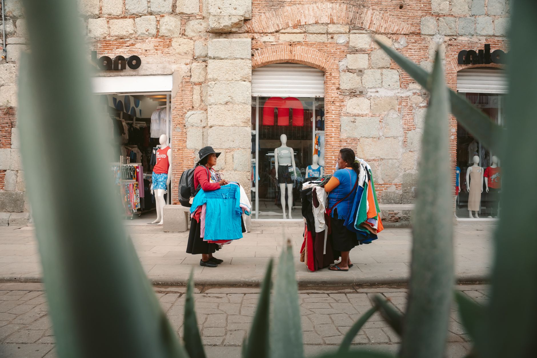 Traveler buying fresh produce at a local market, supporting community businesses and sustainable tourism.