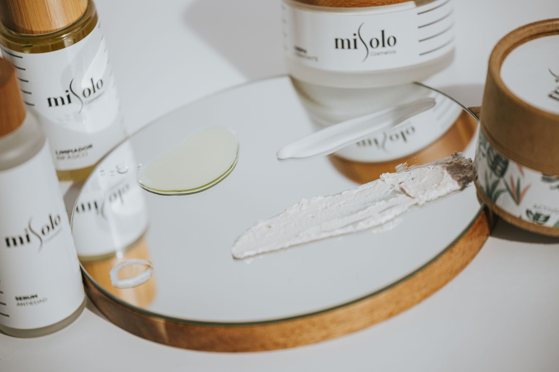 Close-up of natural organic skincare products with botanical ingredients on a wooden surface.