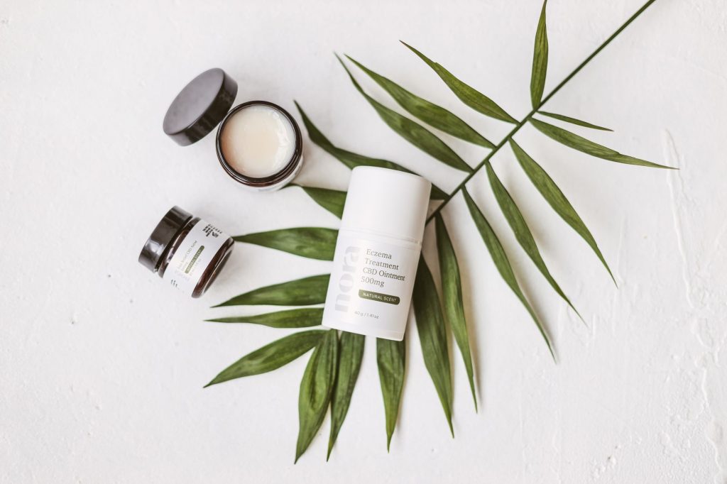 A set of cruelty‑free skincare products displayed on a wooden vanity, featuring natural ingredients