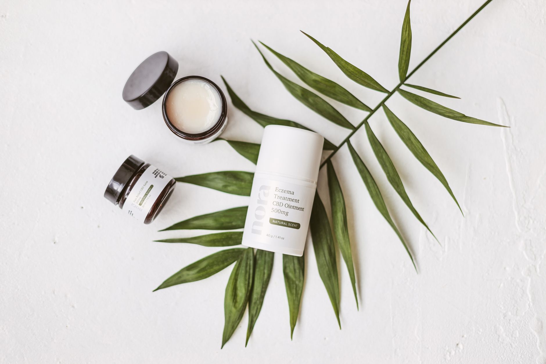 A set of cruelty‑free skincare products displayed on a wooden vanity, featuring natural ingredients